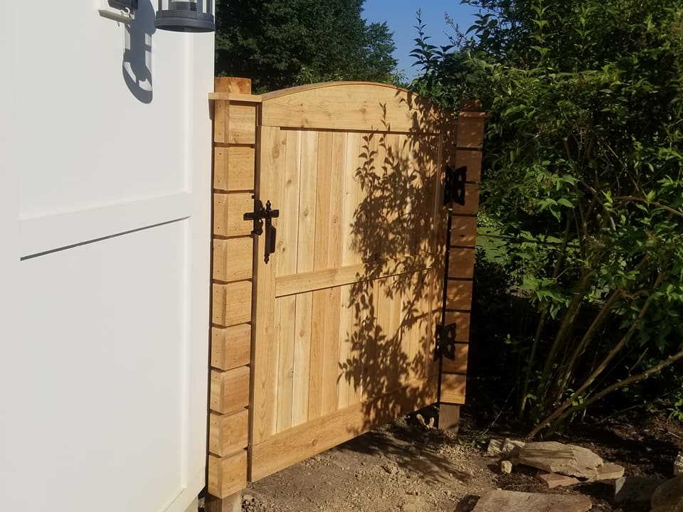 Custom cedar gate with decorative posts and hardware